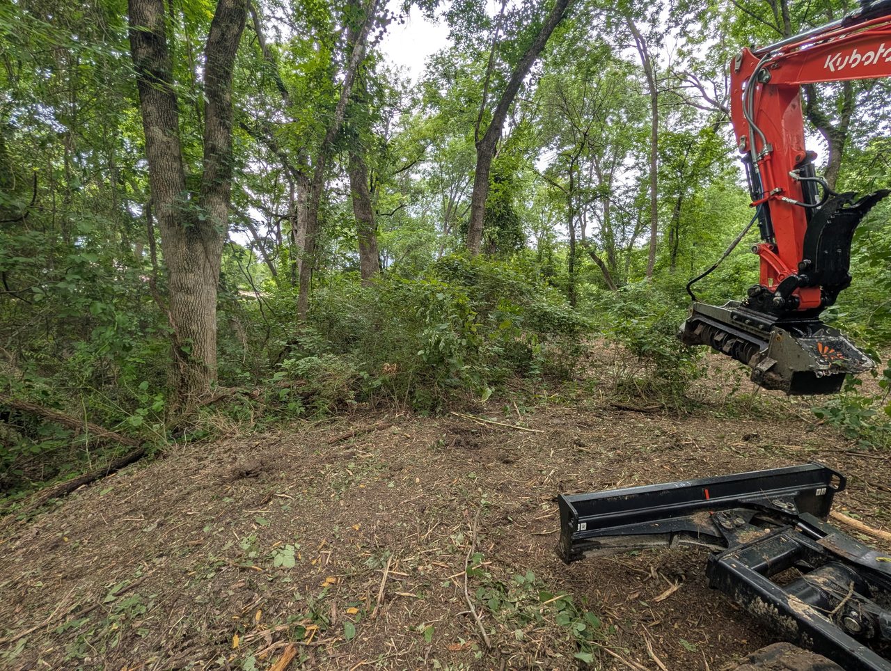 Forestry mulching in progress — the Kubota KX040-5 grinding brush in place